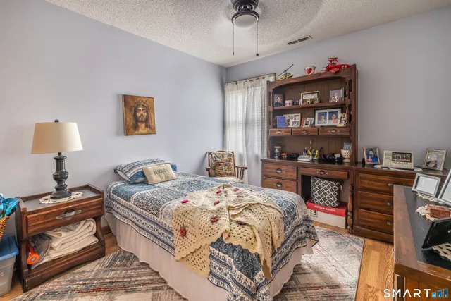 a bedroom with a bed and a chandelier