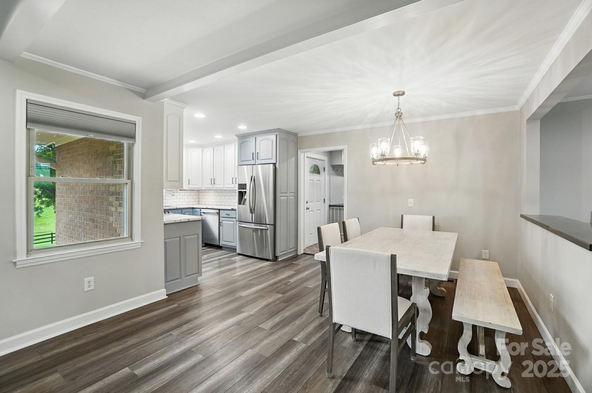 256 Johnson Dairy Road Davidson, NC 28036 - Photo 14 of 44 a view of a dining room with furniture a chandelier and wooden floor