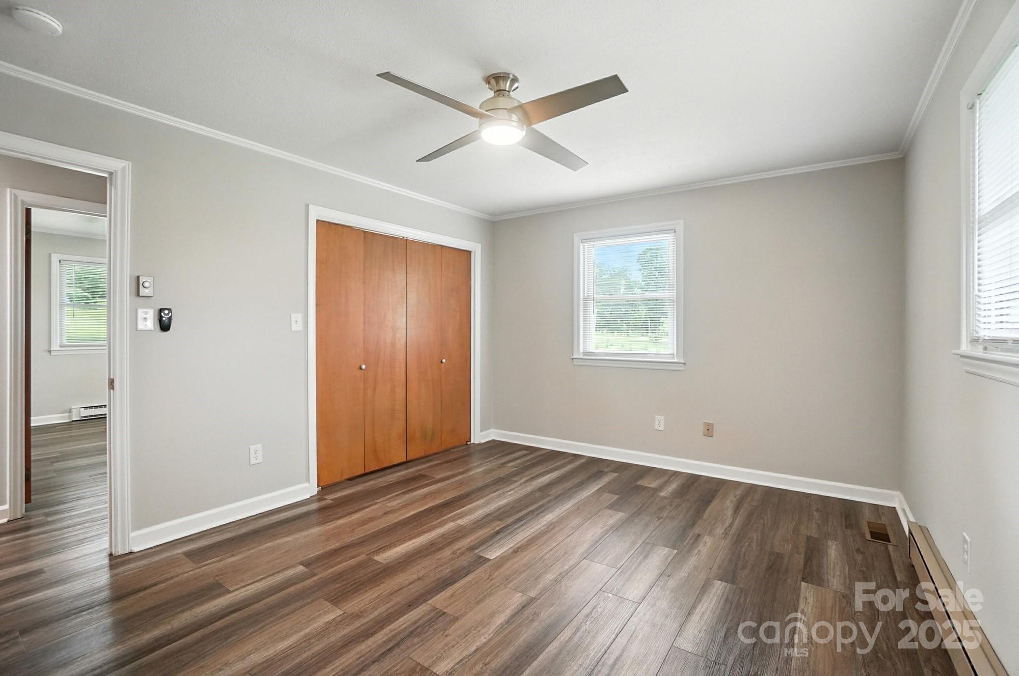 256 Johnson Dairy Road Davidson, NC 28036 - Photo 20 of 44 an empty room with wooden floor and windows