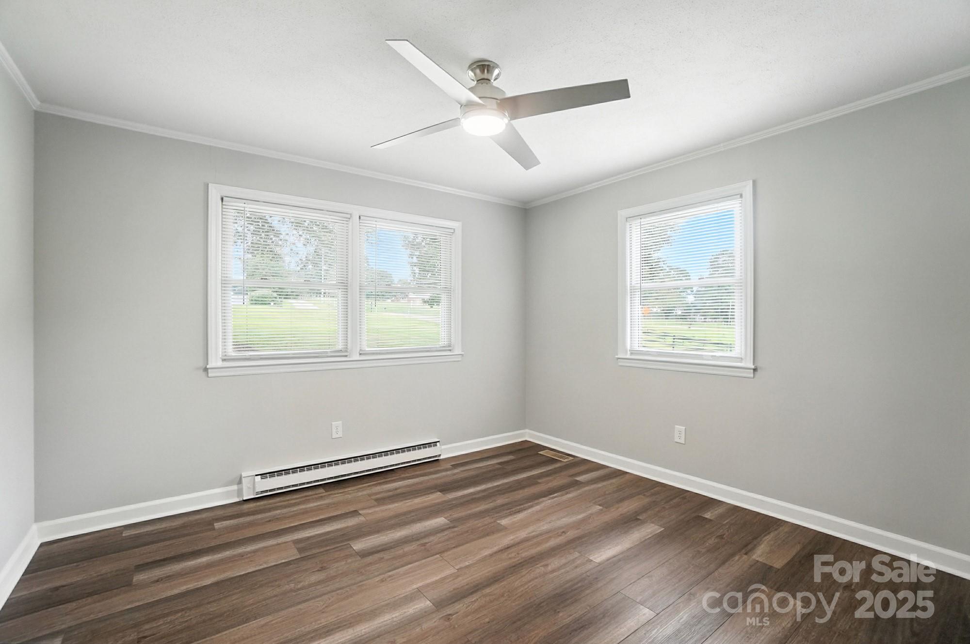 256 Johnson Dairy Road Davidson, NC 28036 - Photo 22 of 44 a view of empty room with wooden floor and fan