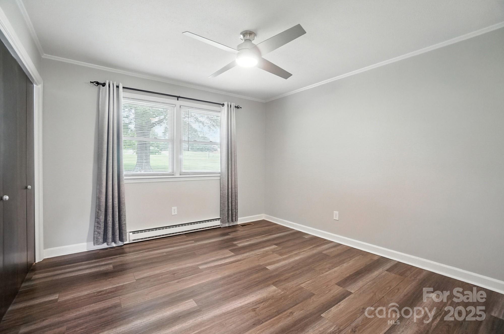 256 Johnson Dairy Road Davidson, NC 28036 - Photo 26 of 44 an empty room with wooden floor and windows