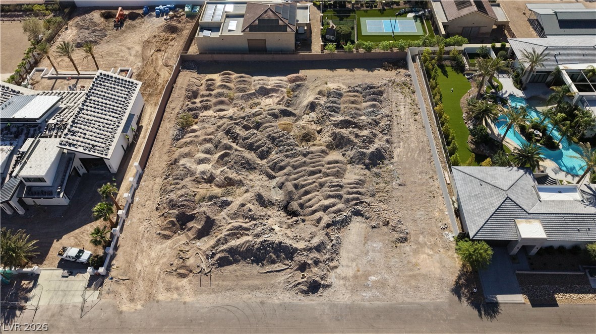 1243 Gloria Mountain Road Henderson, NV 89002 - Photo 2 of 12 A spacious, vacant lot awaits development, surrounded by luxury residences.