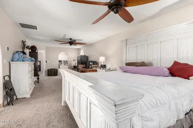 a bathroom with a granite countertop sink a mirror and a shower
