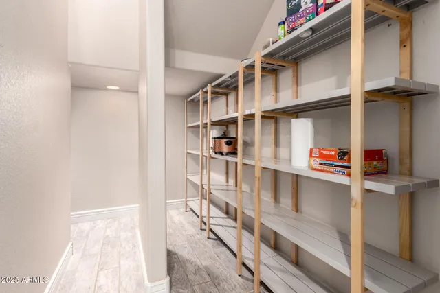 a bathroom with a granite countertop toilet sink and mirror