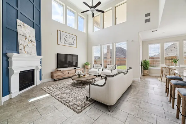 a living room with furniture a flat screen tv and a fireplace