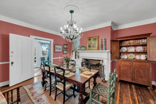 a living room with fireplace furniture and a chandelier
