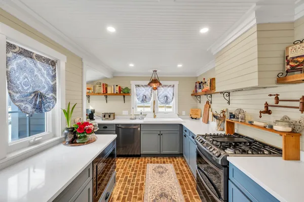 a kitchen with stainless steel appliances granite countertop a stove and a sink