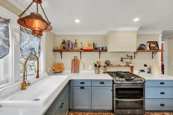 a kitchen with stove and refrigerator