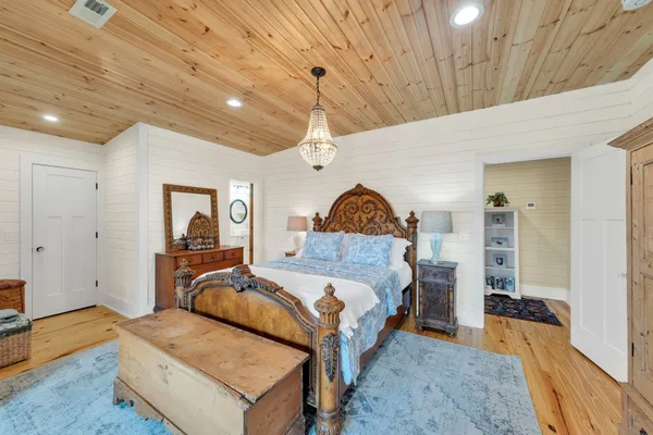 a spacious bedroom with a large bed and a large window