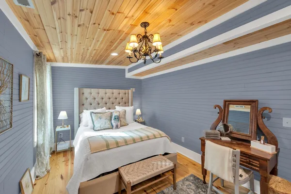 a bedroom with a bed a couch and dresser