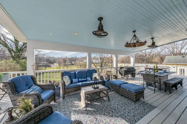 a view of balcony with wooden floor and brick wall