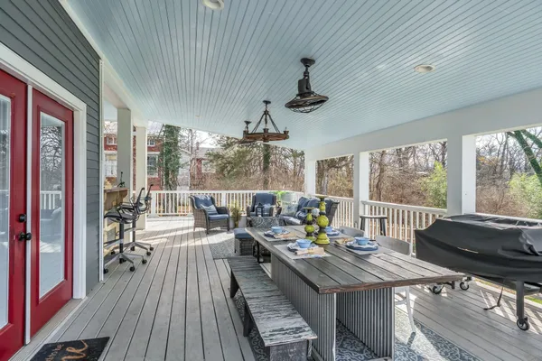 a view of a house with a big yard and large trees
