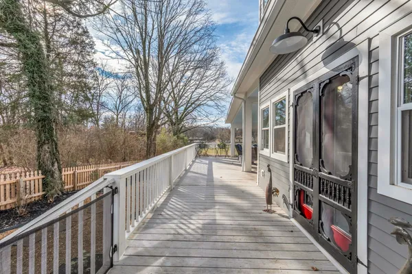 a view of a backyard with wooden fence