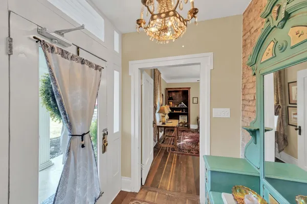 a living room with furniture and a chandelier