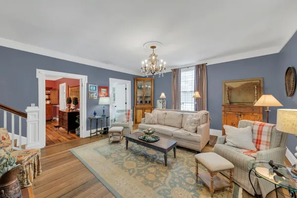 a living room with furniture a fireplace and a window