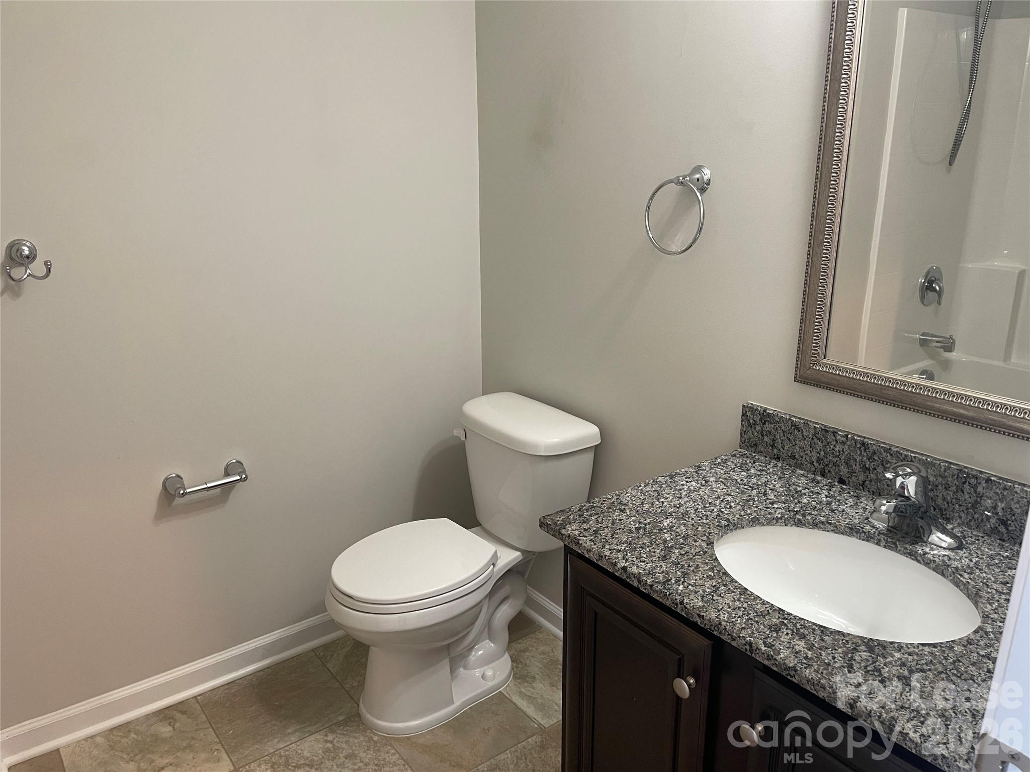 2909 Old Field Road Sumter, SC 29150 - Photo 32 of 39 a bathroom with a granite countertop toilet sink and mirror