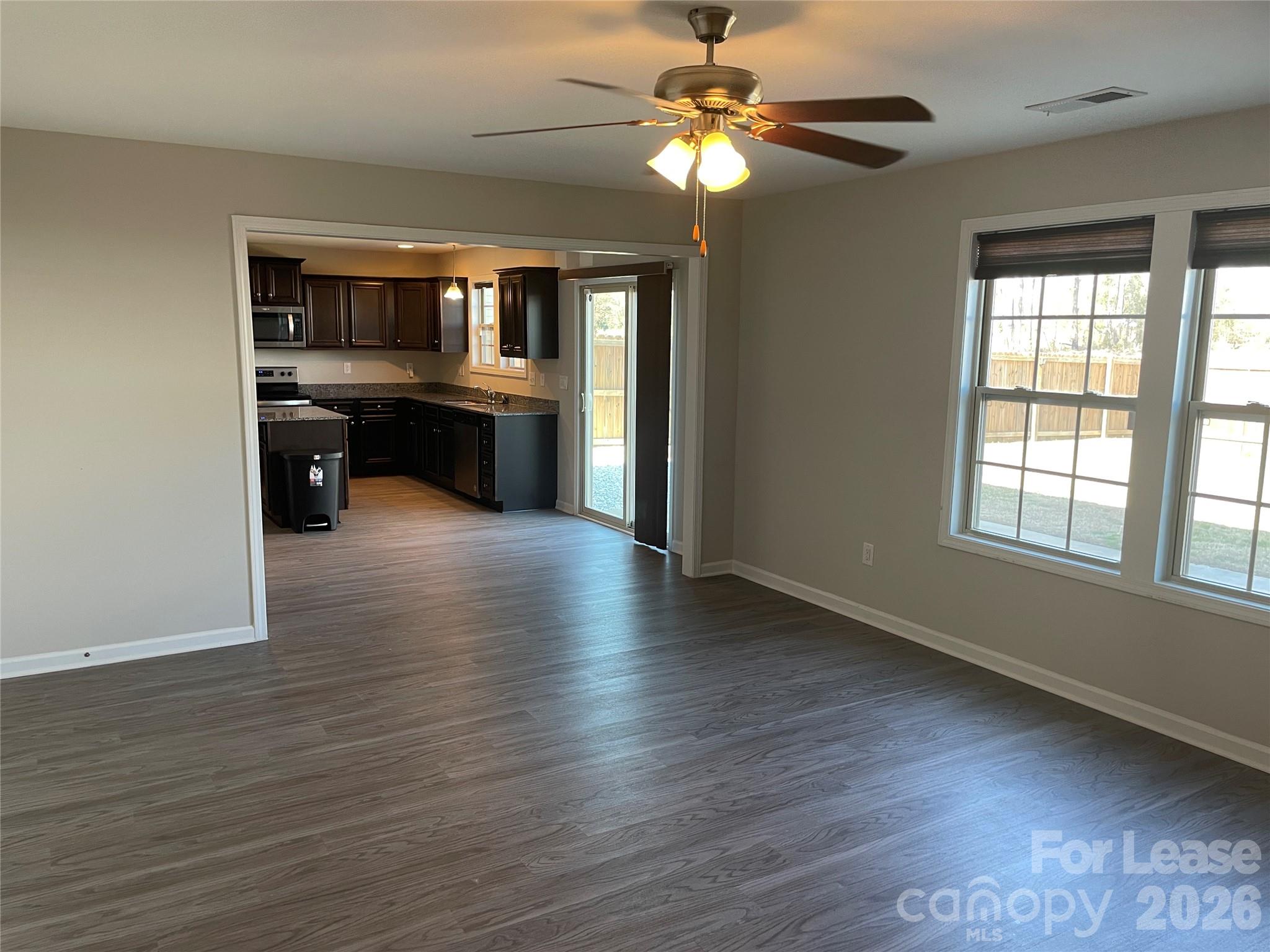 2909 Old Field Road Sumter, SC 29150 - Photo 5 of 39 wooden floor in an empty room with a kitchen