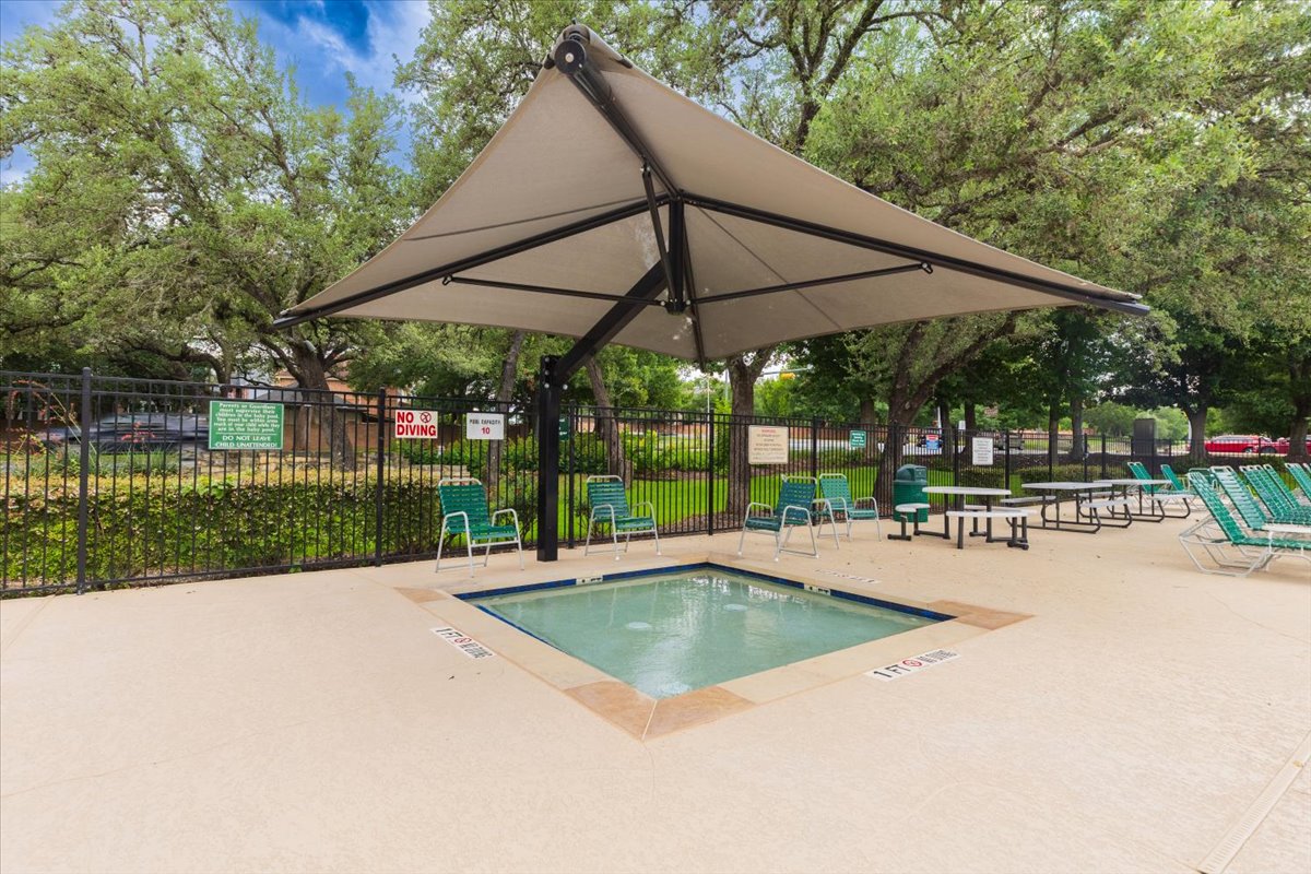 7136 Ridge Oak Road Austin, TX 78749 - Photo 25 of 28 Relax poolside under the shade structure at this inviting community hot tub area.