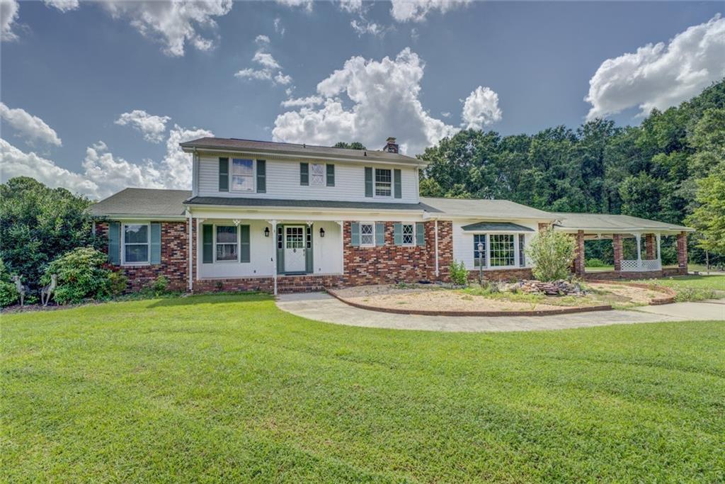 1120 Eugene Road Madison, GA 30650 - Photo 1 of 1 a front view of a house with swimming pool having outdoor seating