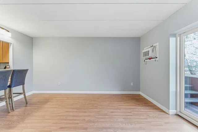 a view of room with window and wooden floor