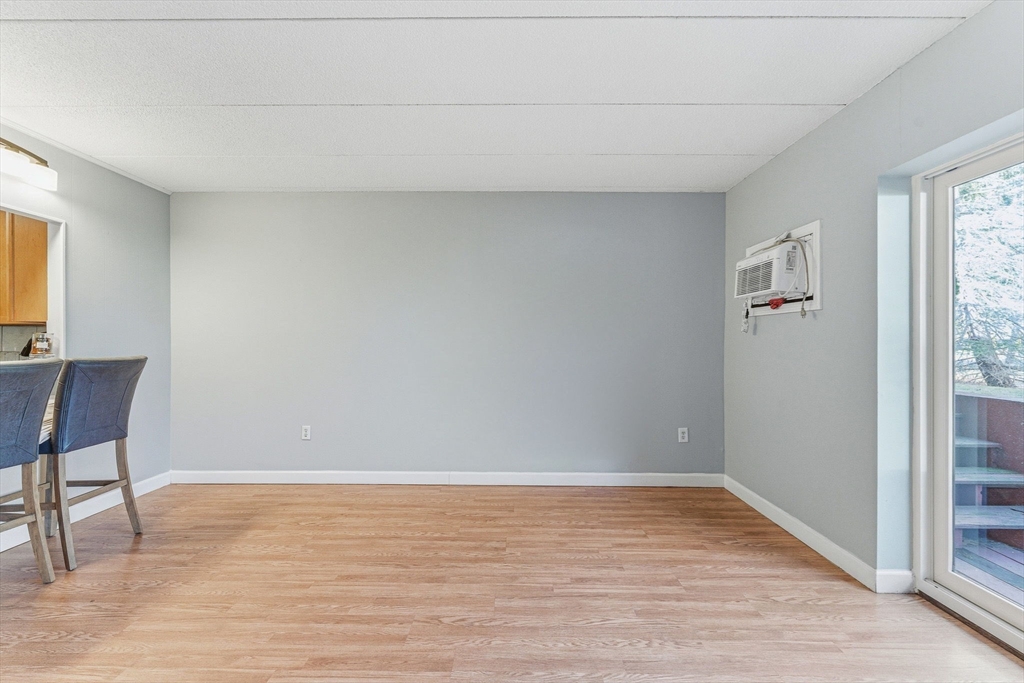 1011 Main Street, Unit 5 Woburn, MA 01801 - Photo 12 of 26 a view of room with window and wooden floor