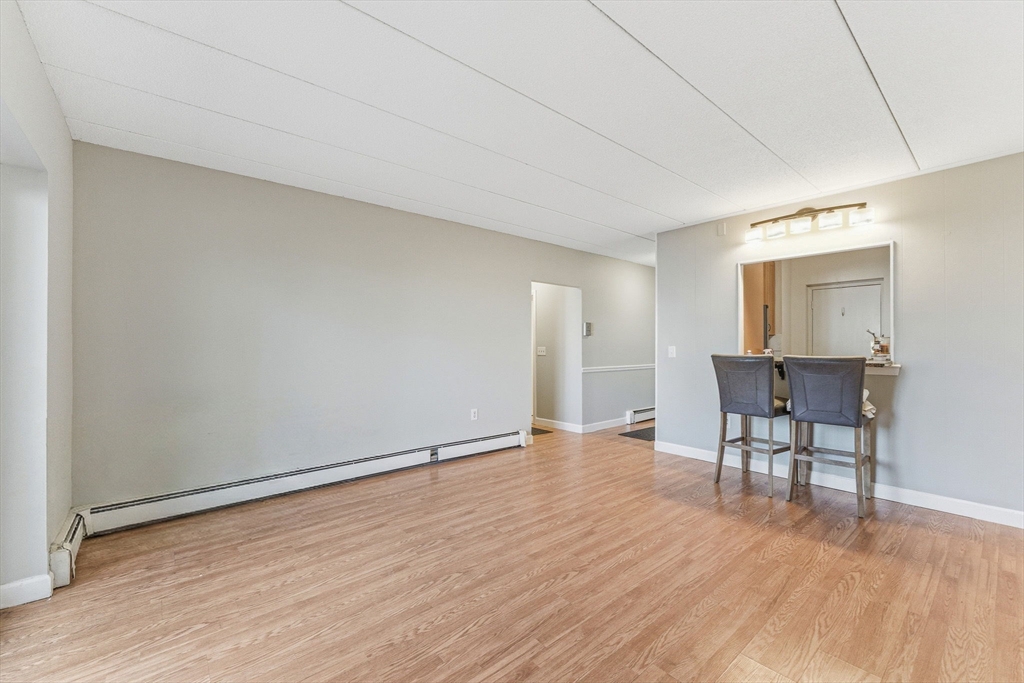 1011 Main Street, Unit 5 Woburn, MA 01801 - Photo 13 of 26 a view of a livingroom with furniture and wooden floor