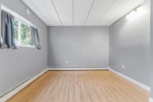 a view of room with window and hardwood floor