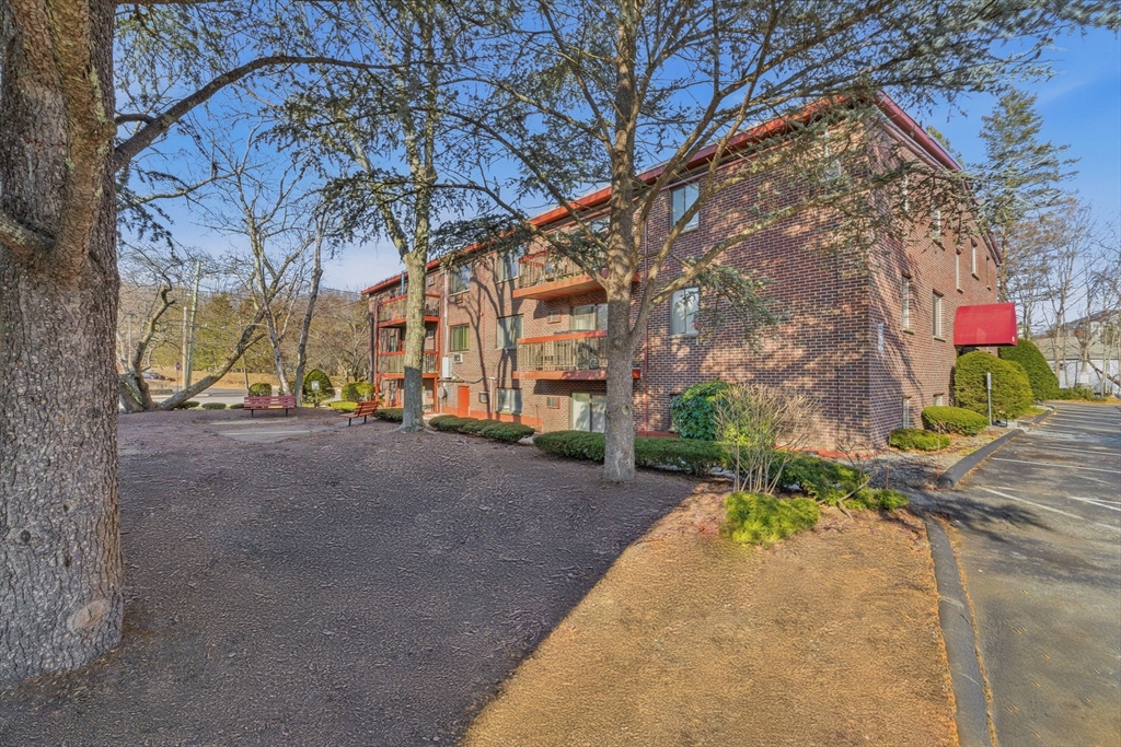 1011 Main Street, Unit 5 Woburn, MA 01801 - Photo 3 of 26 a view of a street with a building in the background