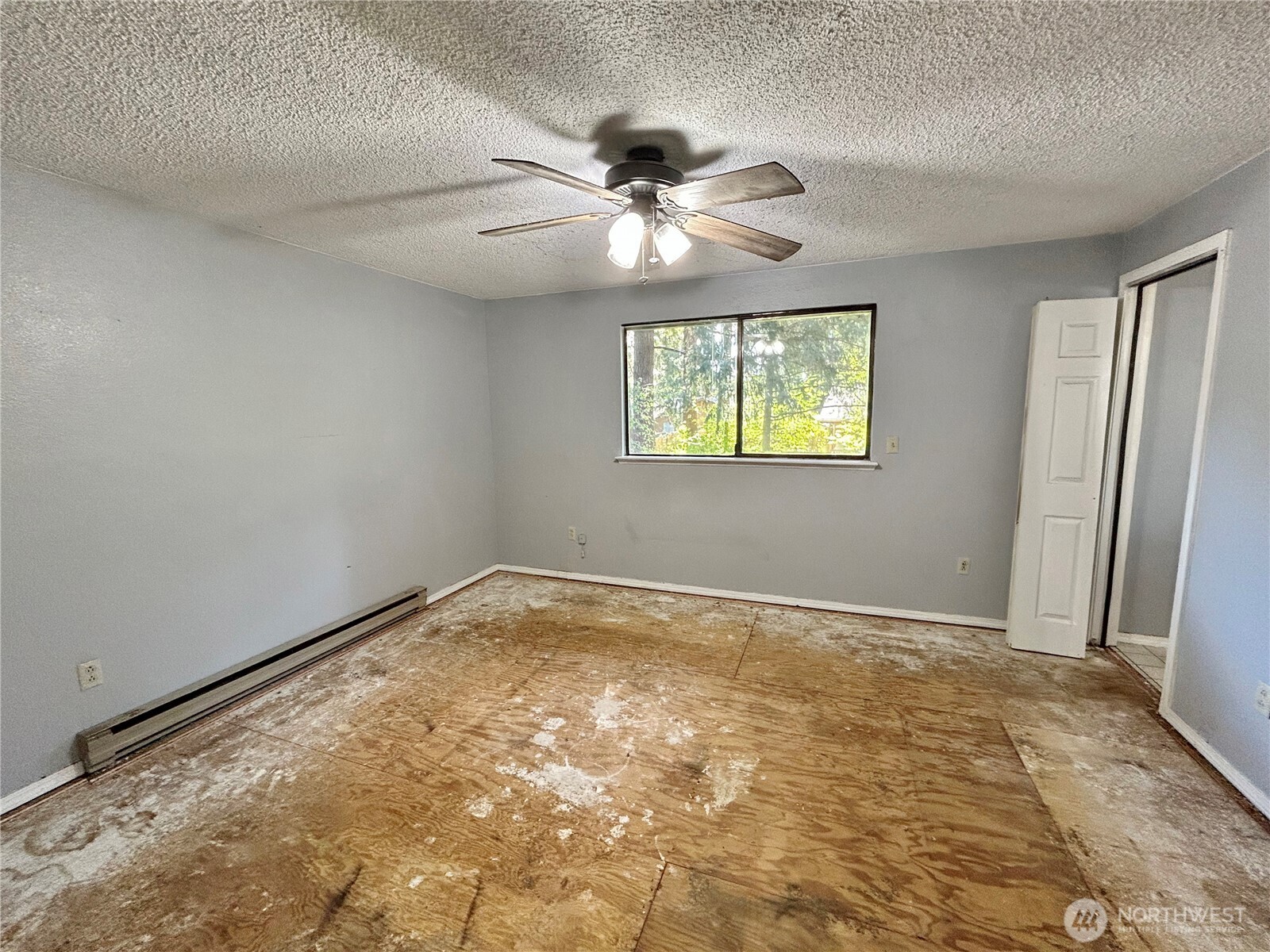 7305 38th Loop Southeast Lacey, WA 98503 - Photo 11 of 32 an empty room with windows and fan