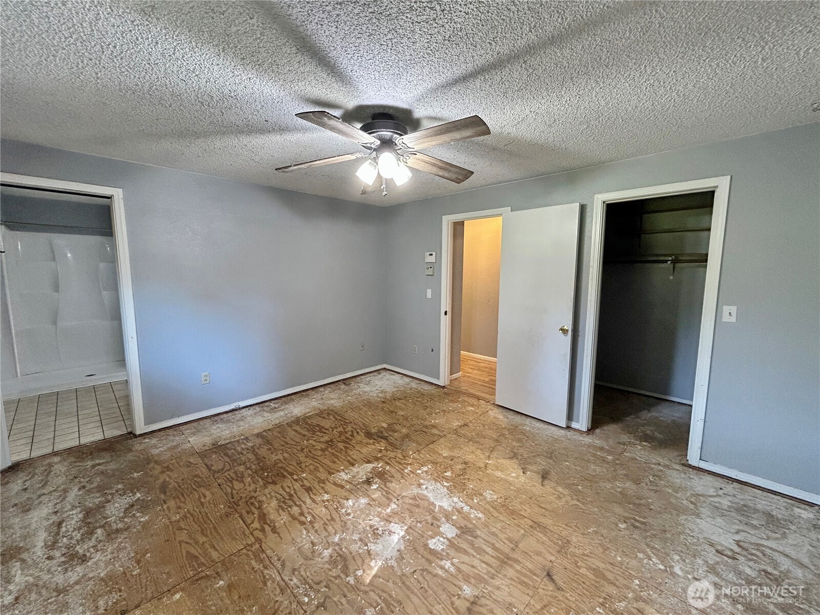 7305 38th Loop Southeast Lacey, WA 98503 - Photo 12 of 32 an empty room with closet and a ceiling fan