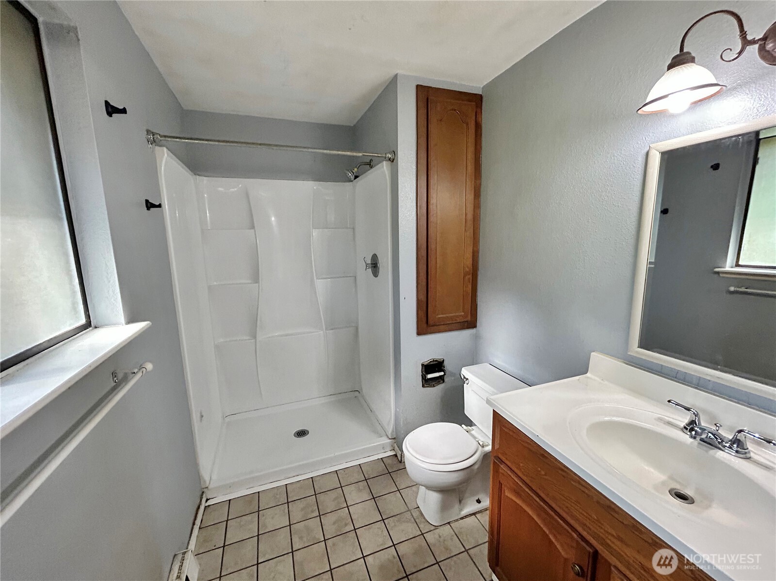 7305 38th Loop Southeast Lacey, WA 98503 - Photo 13 of 32 a bathroom with a sink a toilet and shower