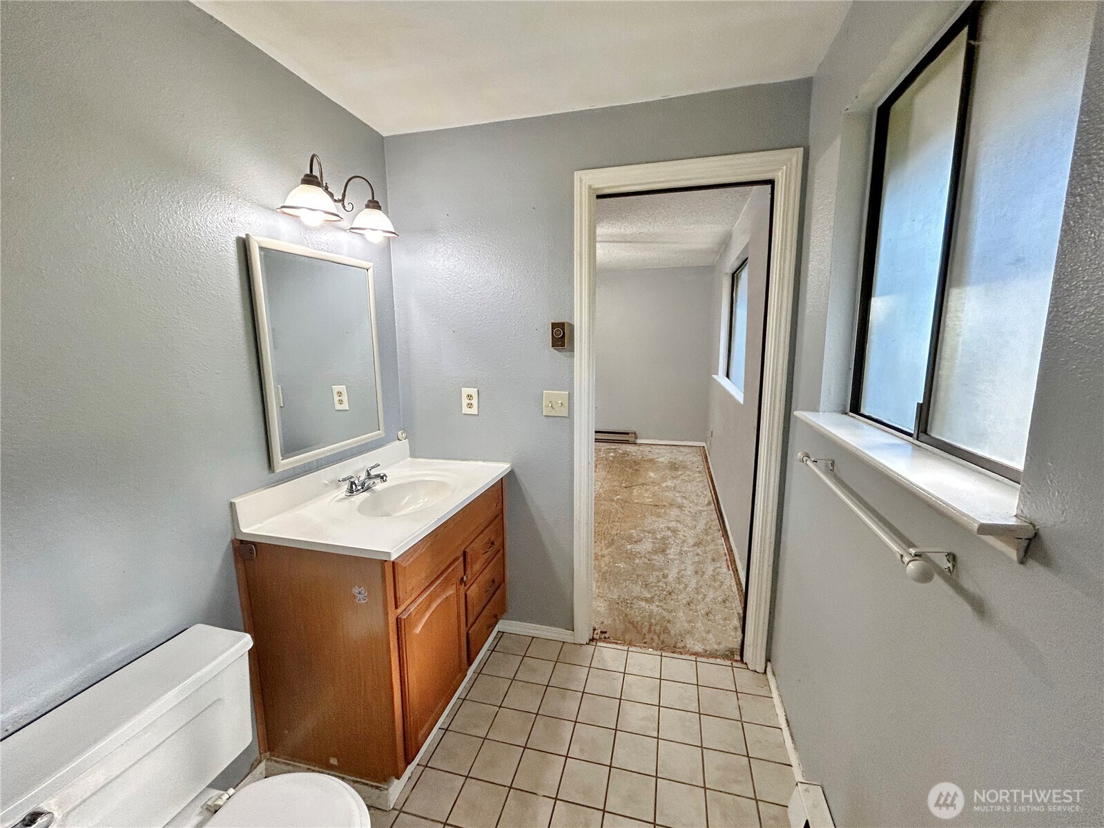 7305 38th Loop Southeast Lacey, WA 98503 - Photo 14 of 32 a bathroom with a sink a toilet and mirror