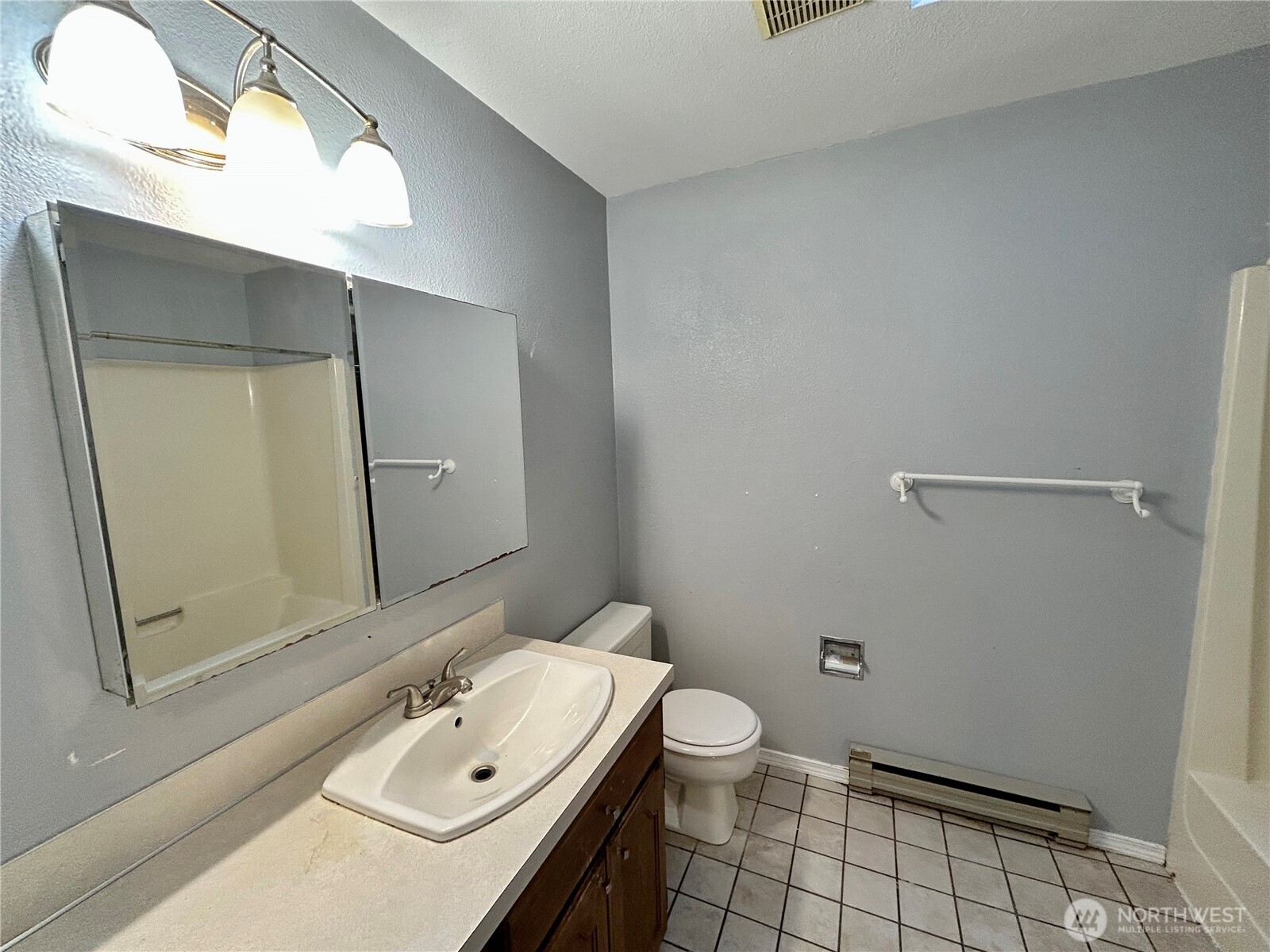 7305 38th Loop Southeast Lacey, WA 98503 - Photo 17 of 32 a bathroom with a sink a toilet and a mirror