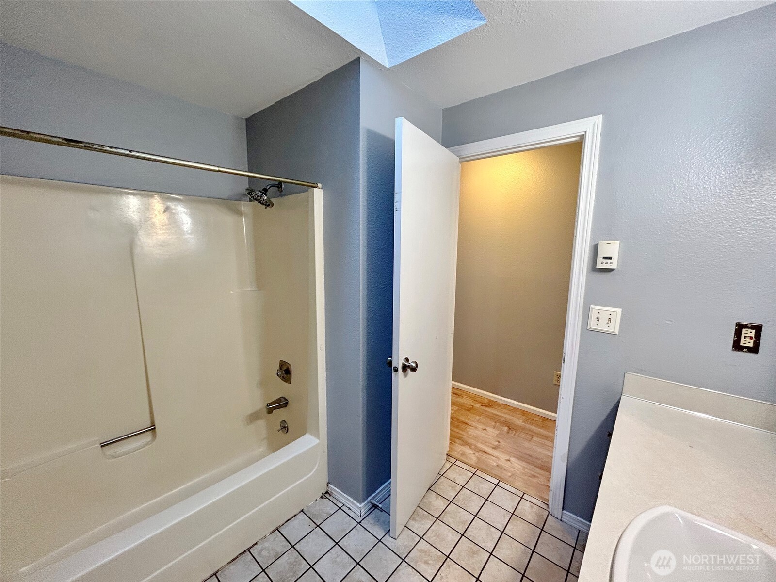 7305 38th Loop Southeast Lacey, WA 98503 - Photo 18 of 32 a bathroom with a bathtub and a shower