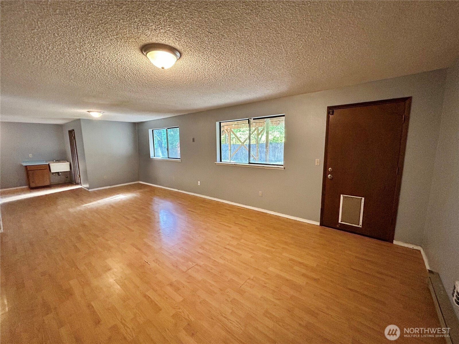 7305 38th Loop Southeast Lacey, WA 98503 - Photo 22 of 32 a view of an empty room with window and a wooden floor