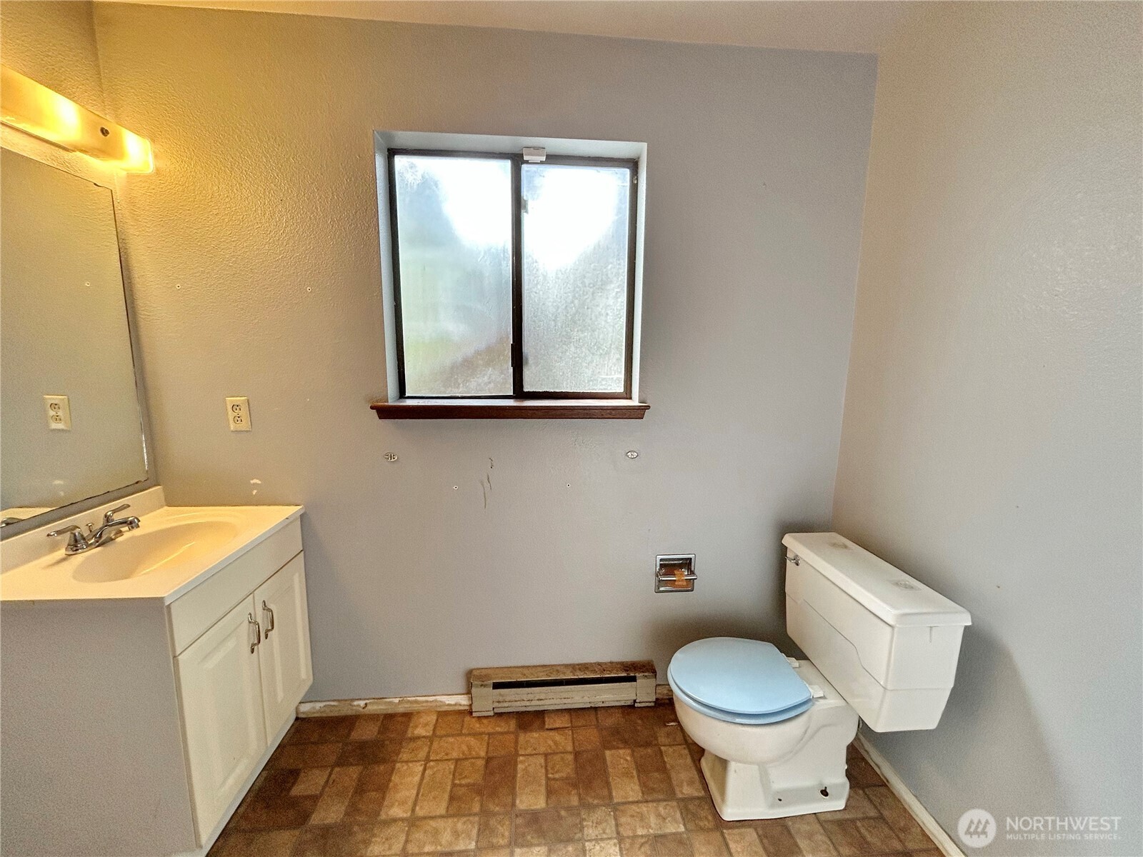 7305 38th Loop Southeast Lacey, WA 98503 - Photo 23 of 32 a bathroom with a toilet sink and mirror