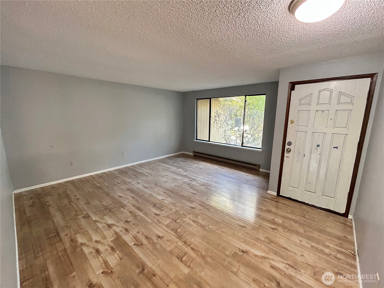 7305 38th Loop Southeast Lacey, WA 98503 - Photo 3 of 32 a view of empty room with wooden floor and fan