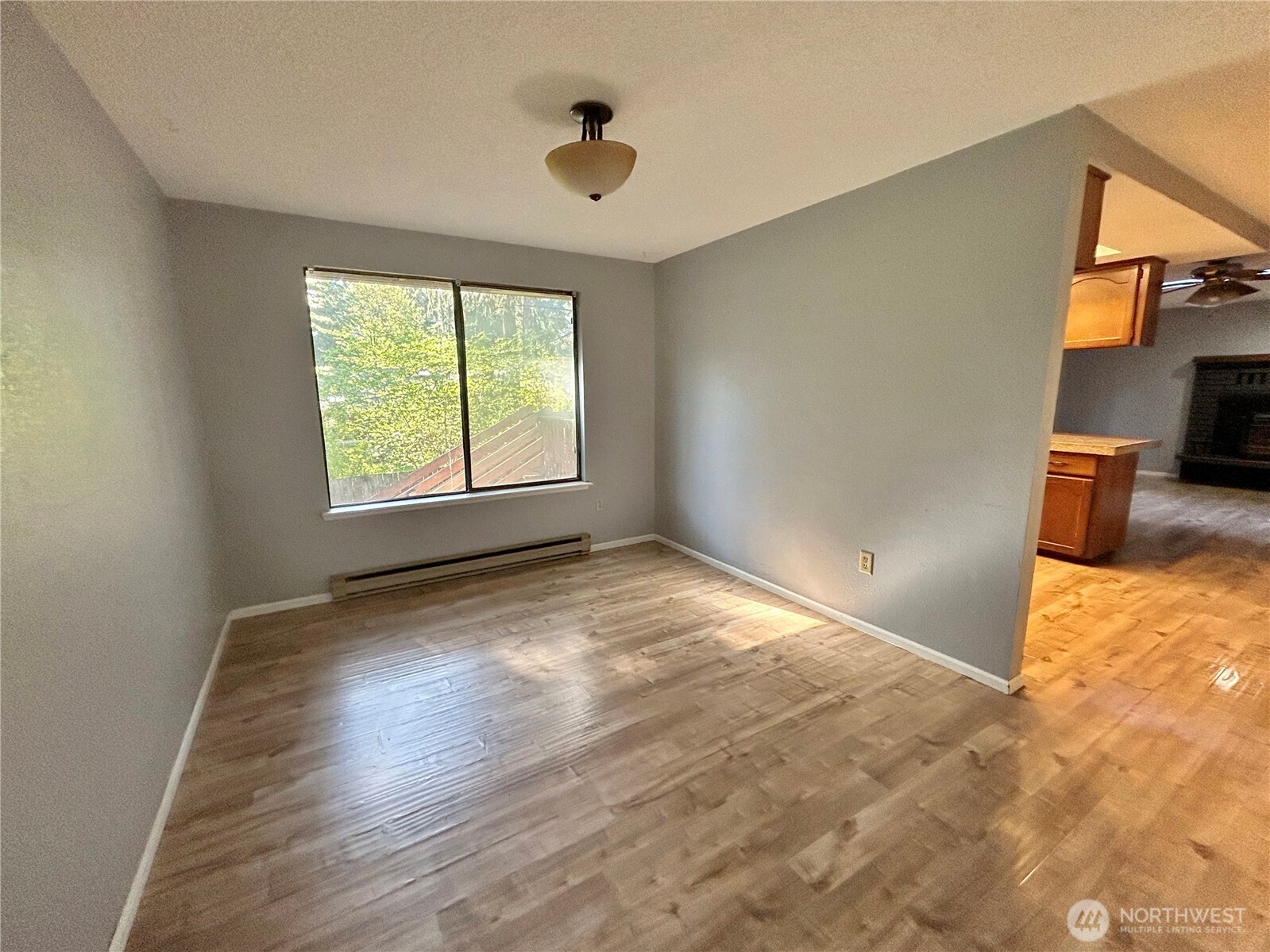 7305 38th Loop Southeast Lacey, WA 98503 - Photo 5 of 32 a view of empty room with wooden floor and fan