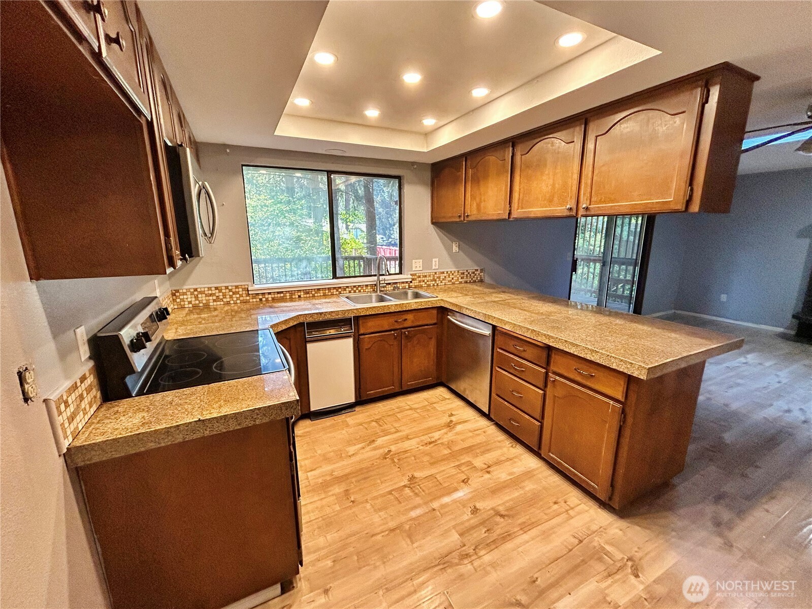 7305 38th Loop Southeast Lacey, WA 98503 - Photo 7 of 32 a kitchen with stainless steel appliances granite countertop a sink and a refrigerator