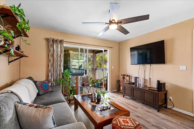a living room with furniture and wooden floor