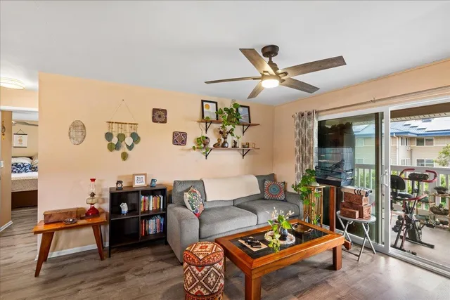 a living room with furniture and a floor to ceiling window
