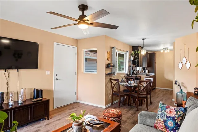 a living room with furniture and wooden floor