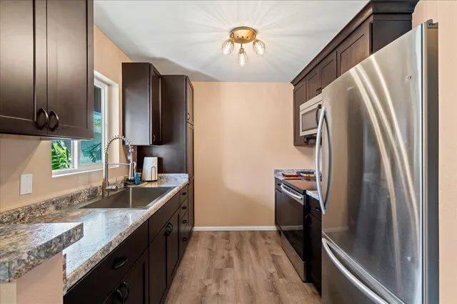 a kitchen with a sink appliances and cabinets