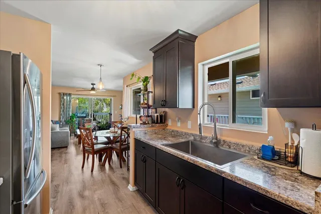 a dining room with furniture a chandelier and wooden floor
