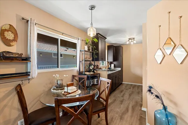 a view of a dining room with furniture and wooden floor