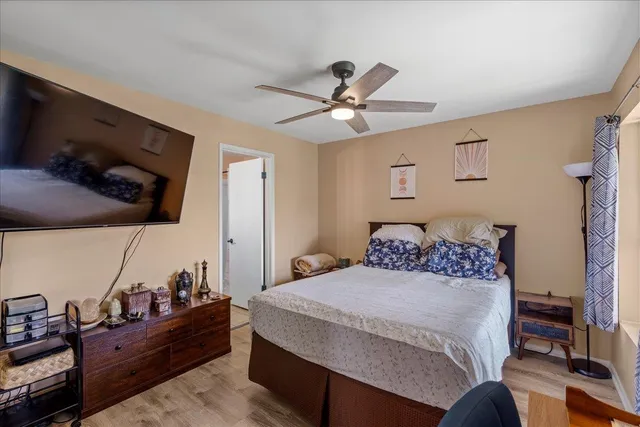 a bedroom with a bed and wooden floor