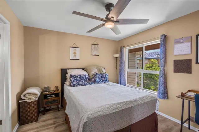 a bedroom with a large bed and a flat tv screen