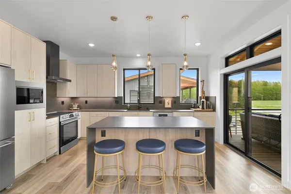a kitchen with granite countertop a sink and a refrigerator