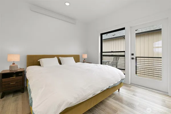 a large white bed in a white room