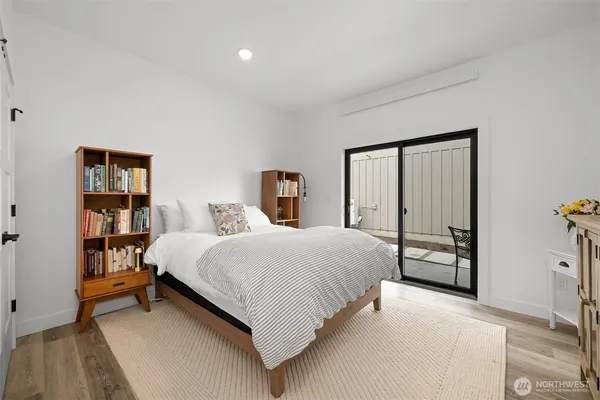 a bedroom with a flat screen tv and a bed